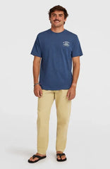 Blue Billabong surf t-shirt with chest logo, paired with beige pants and flip-flops for beachwear style