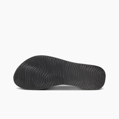 Black wetsuit boot sole with wavy grip pattern for watersports
