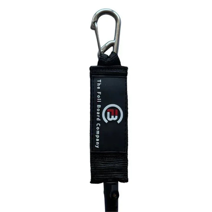 The Foil Board Company wing foil board leash with black padded strap and metal clip.